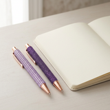 Bling Pens styled beside a notebook