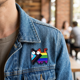 Cat pride pin worn on a denim jacket